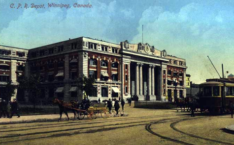 a colored photo of 181 Higgins, with a visible streetcar on the road, along with horse wagons. From the 19th century.