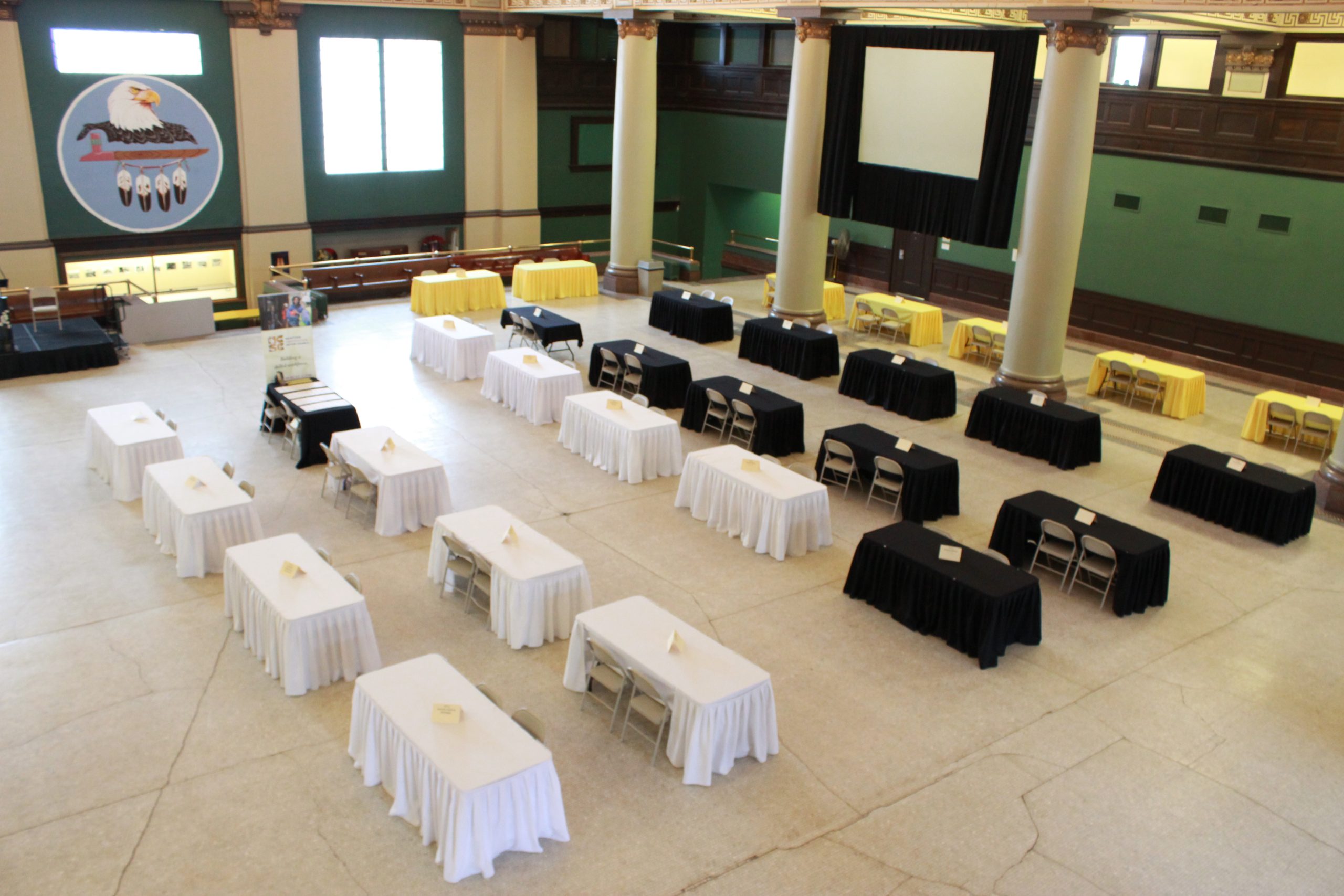 The rotunda within 181 Higgins, populated with tables and chairs for an event
