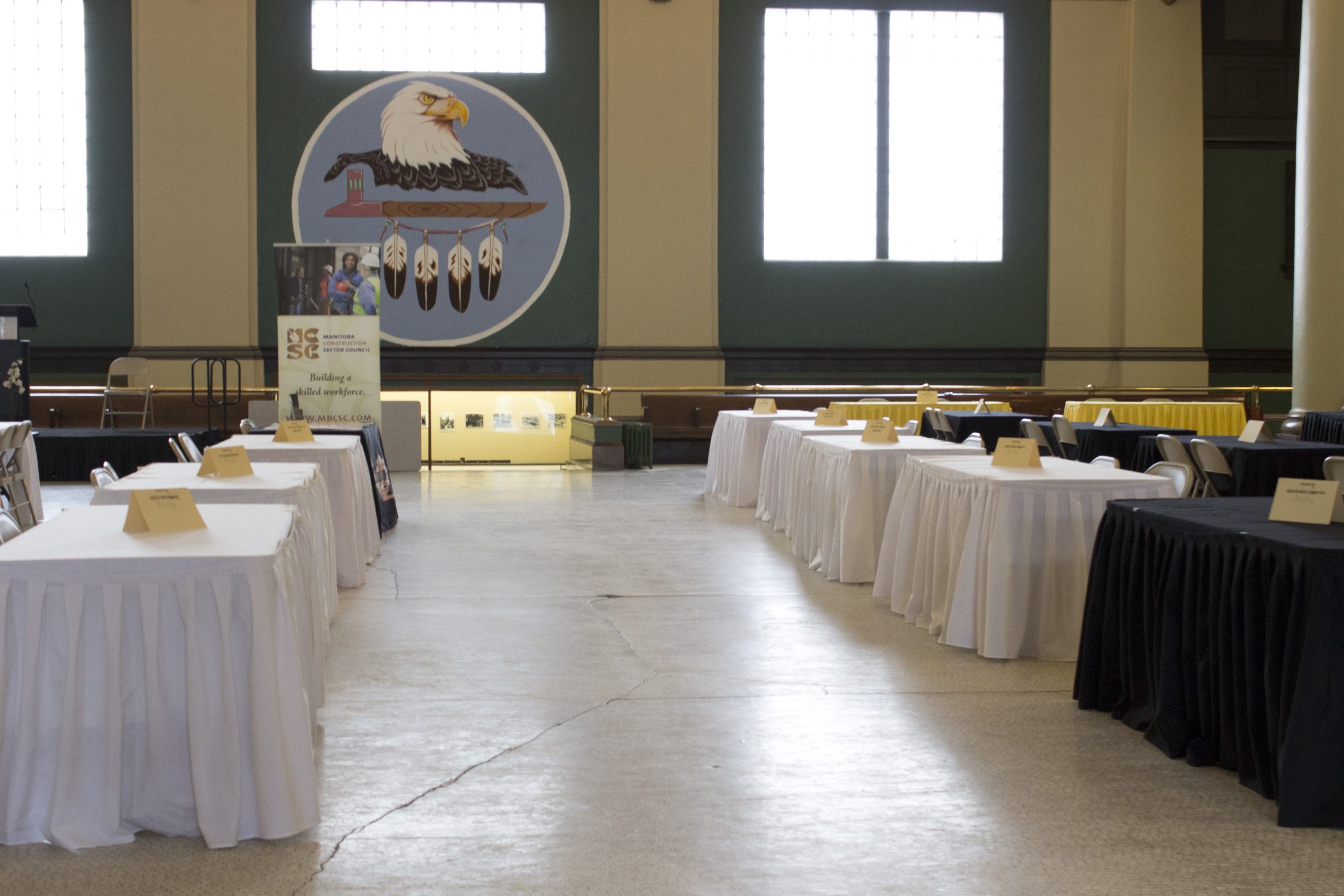 The rotunda within 181 Higgins, populated with tables and chairs for an event.
