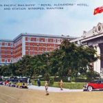 a color photo of 181 Higgins pillar doors covered by greenery, and to the left the Hotel Alexandra. From the 19th century,